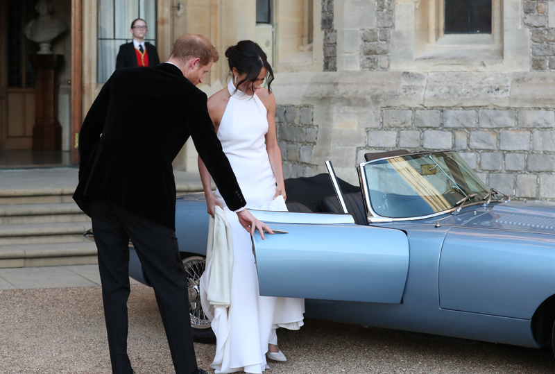 Prince Harry, duke of Sussex, and his new bride, the duchess of Sussex, leave Windsor Castle after their wedding to attend an evening reception at Frogmore House, hosted by the prince of Wales, on May 19, 2018, in Windsor, England.
